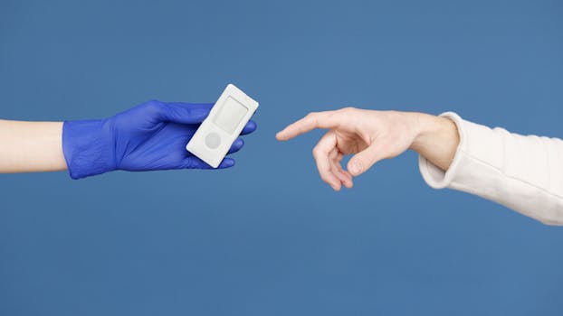 A medical professional hands a glucometer to a patient, symbolizing diabetic care and awareness.